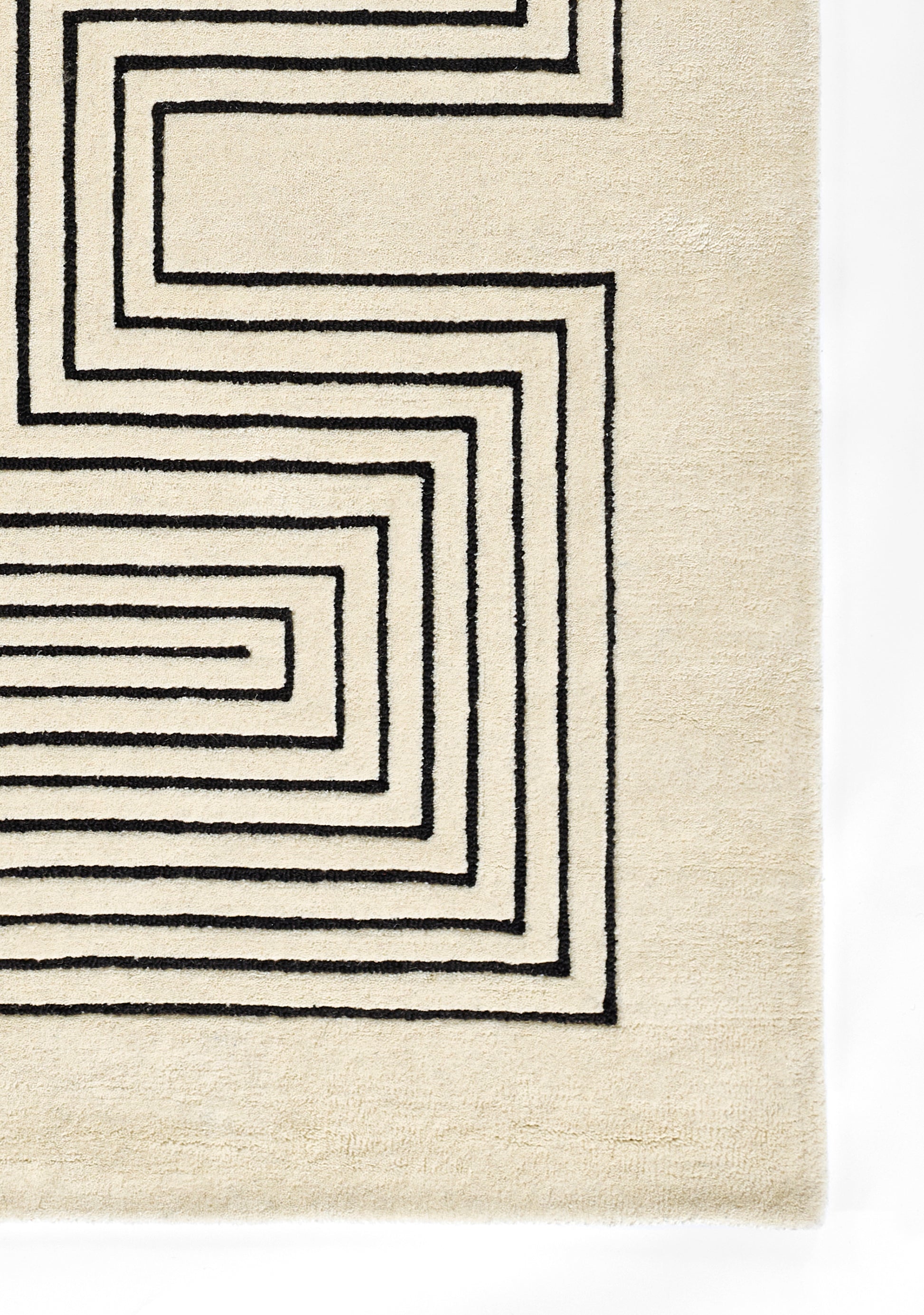 Beige rectangular runner rug with a bold black geometric spiral border; woven textile for modern minimalist decor.