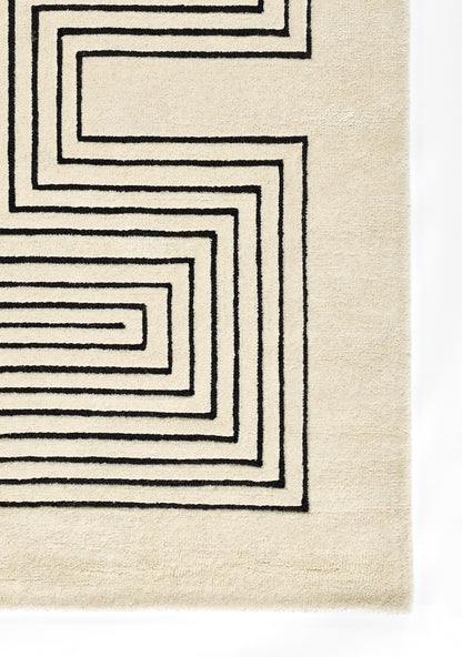 Beige rectangular runner rug with a bold black geometric spiral border; woven textile for modern minimalist decor.