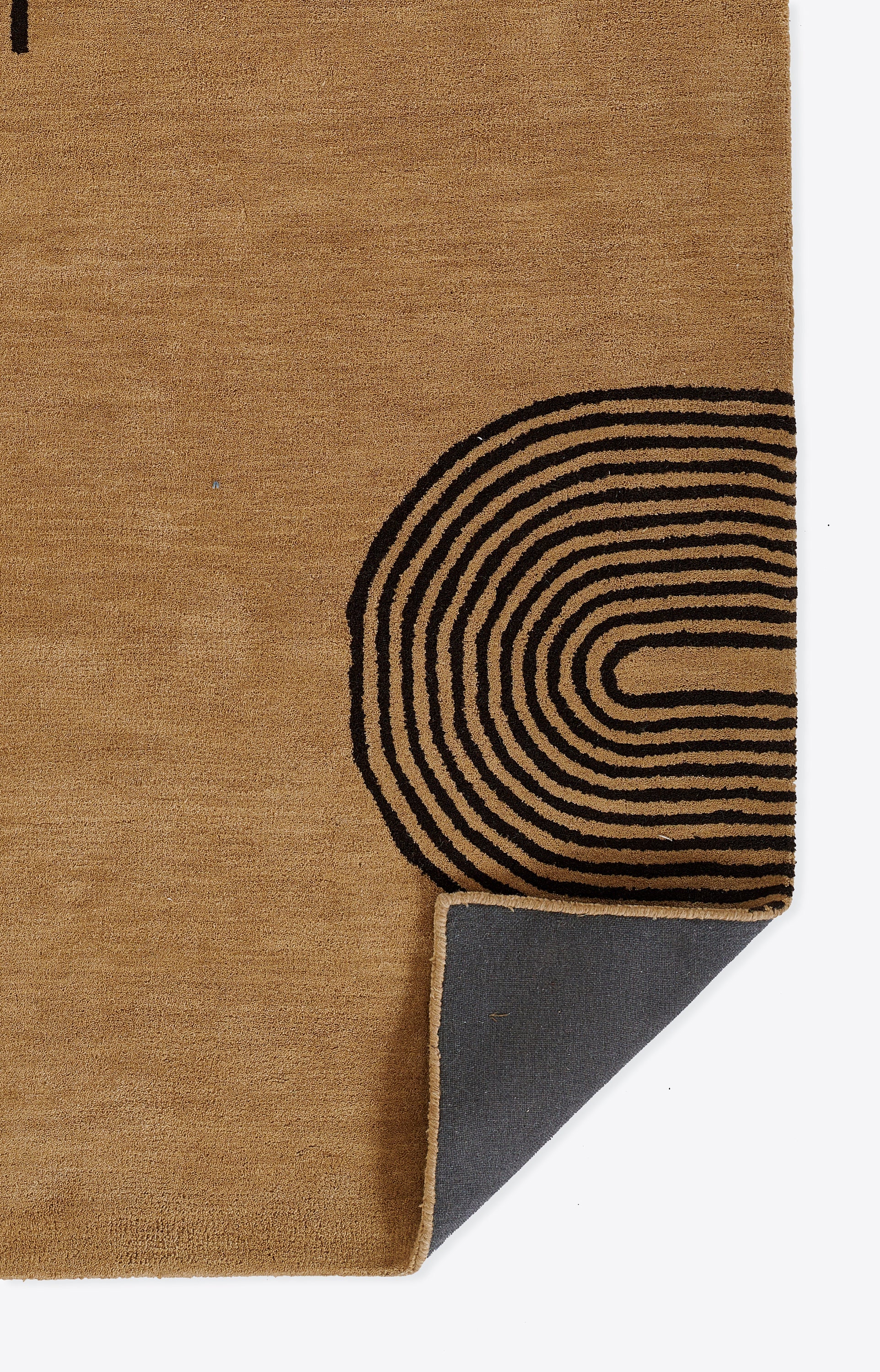 Beige jute rug with black concentric curved loop motif; corner folded to show gray underside.