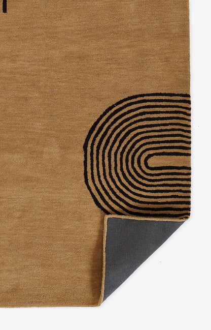 Beige natural-fiber rug with black concentric arc pattern near the corner; folded edge shows gray underside.