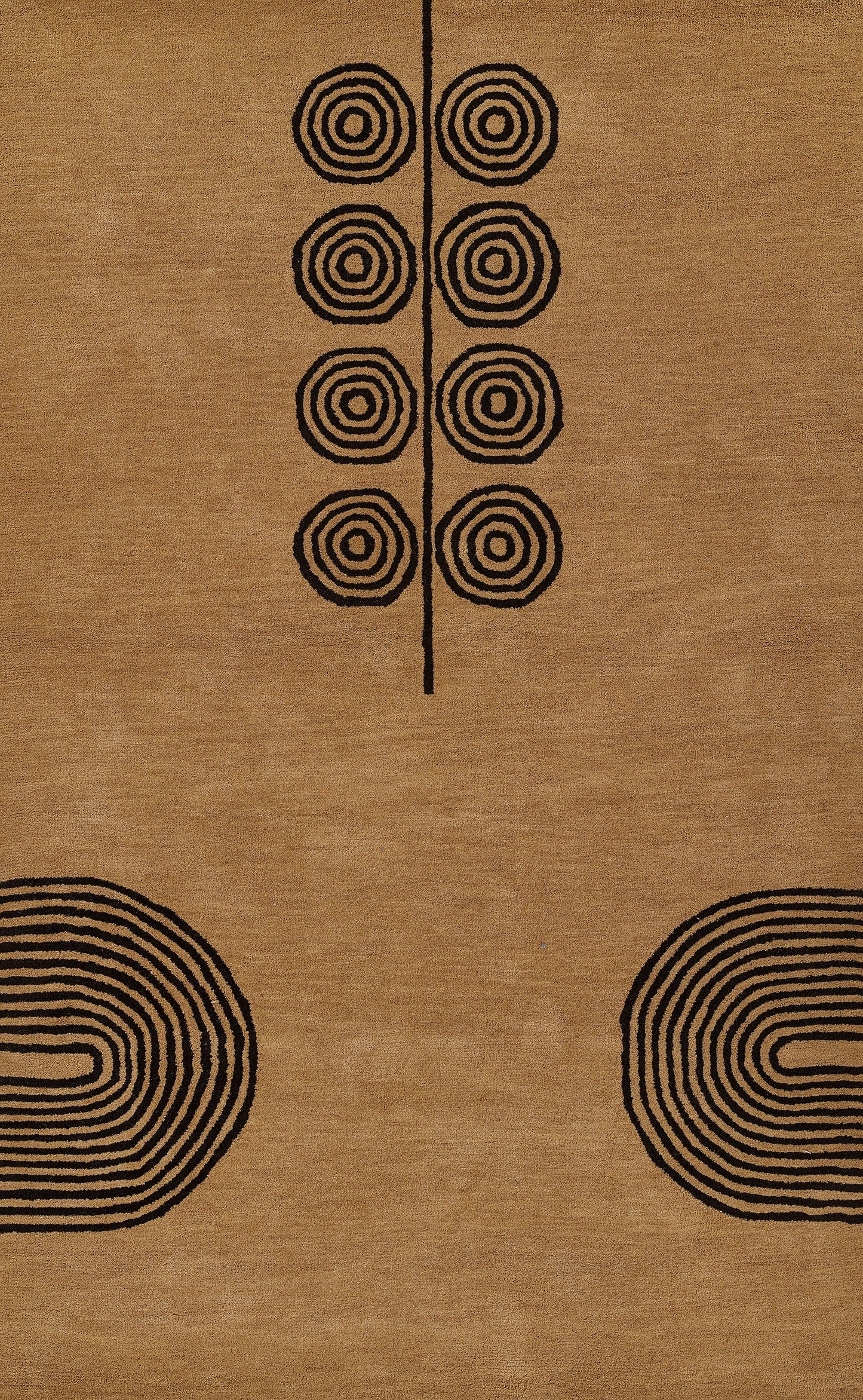 Tan woven rug with black concentric circles along a central line and large edge spirals; geometric mid-century style.