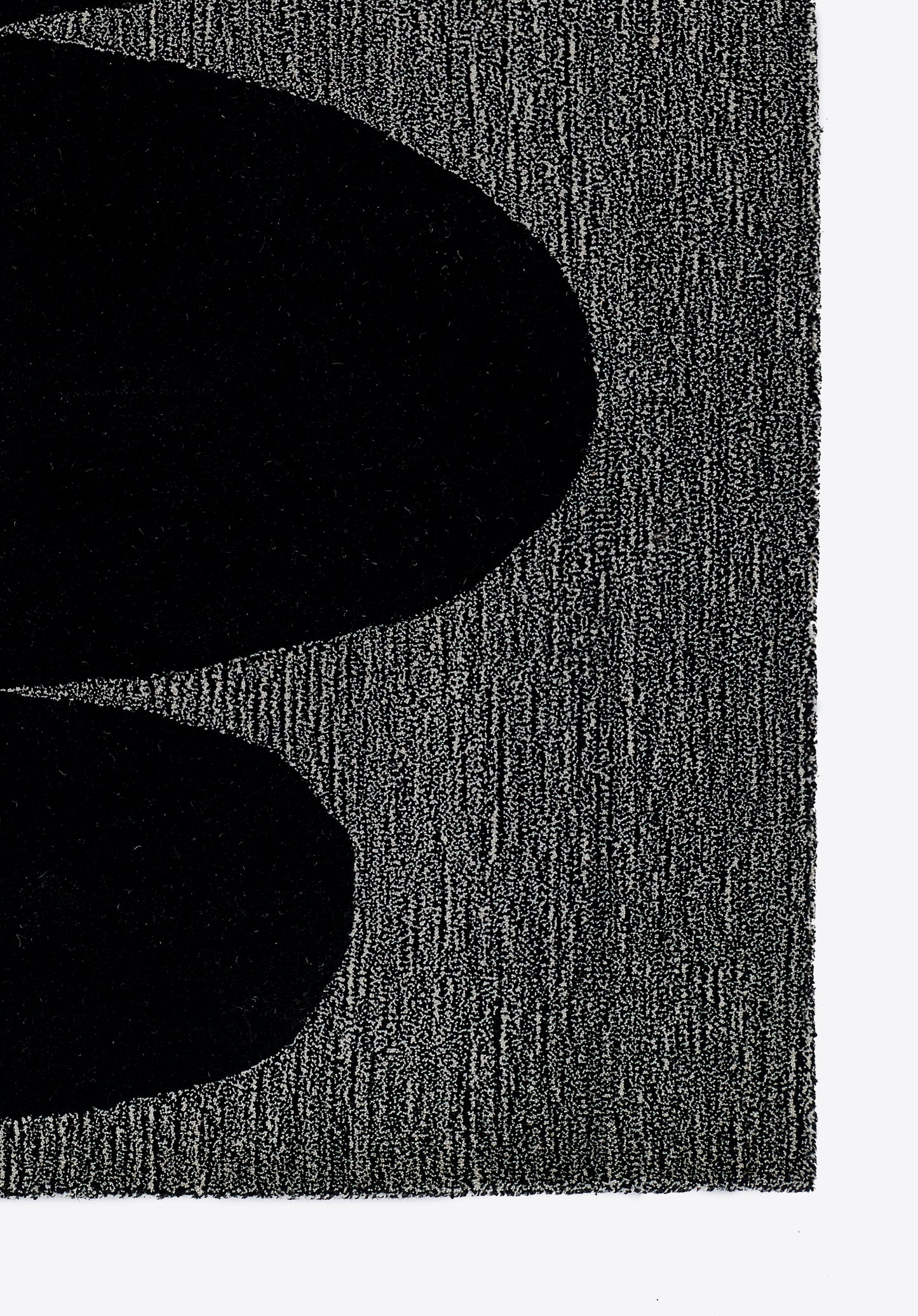 Close-up of two large black oval shapes on a gray textured background, abstract monochrome rug design.