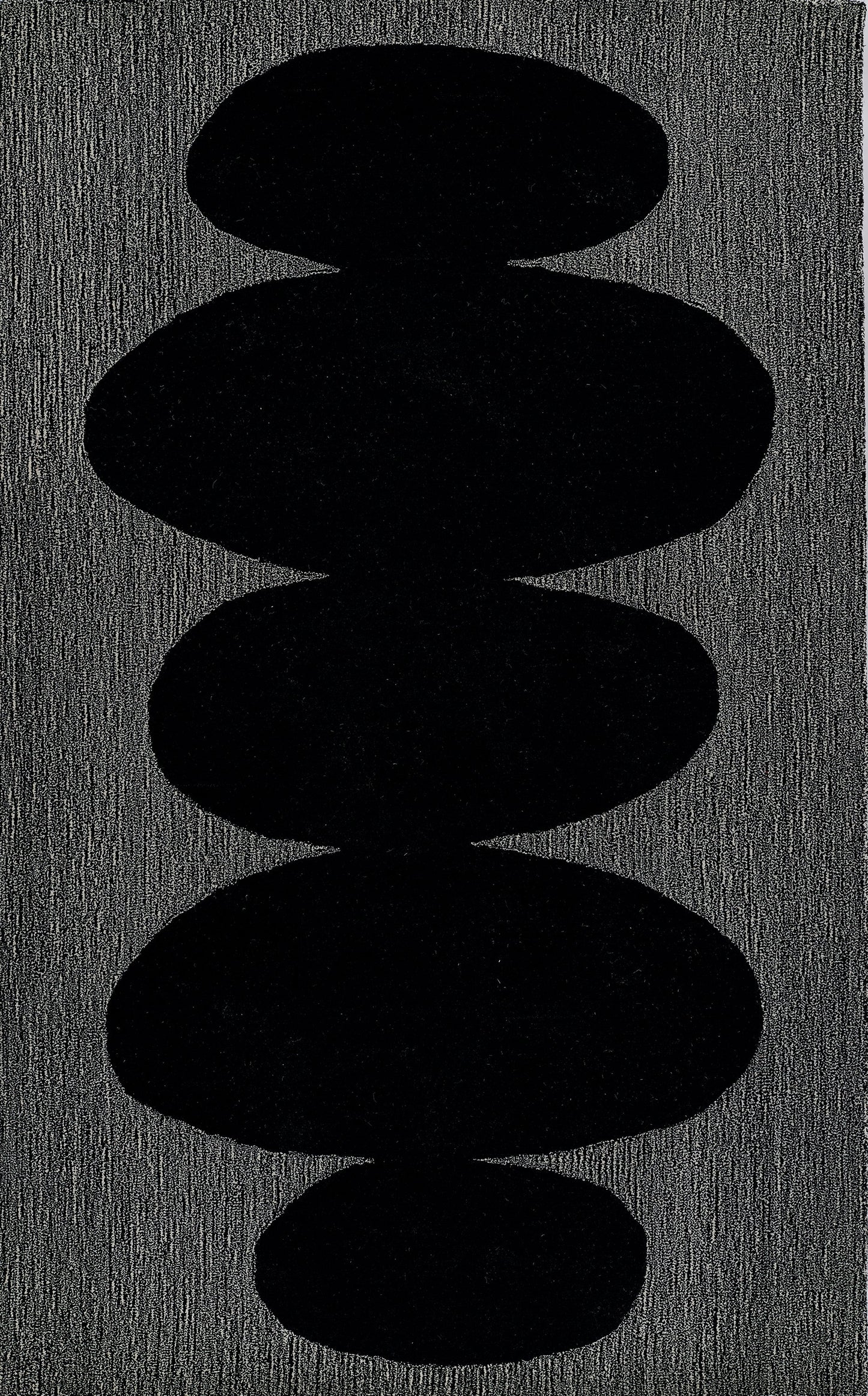 Vertical stack of five smooth black pebble shapes on a charcoal textured surface.