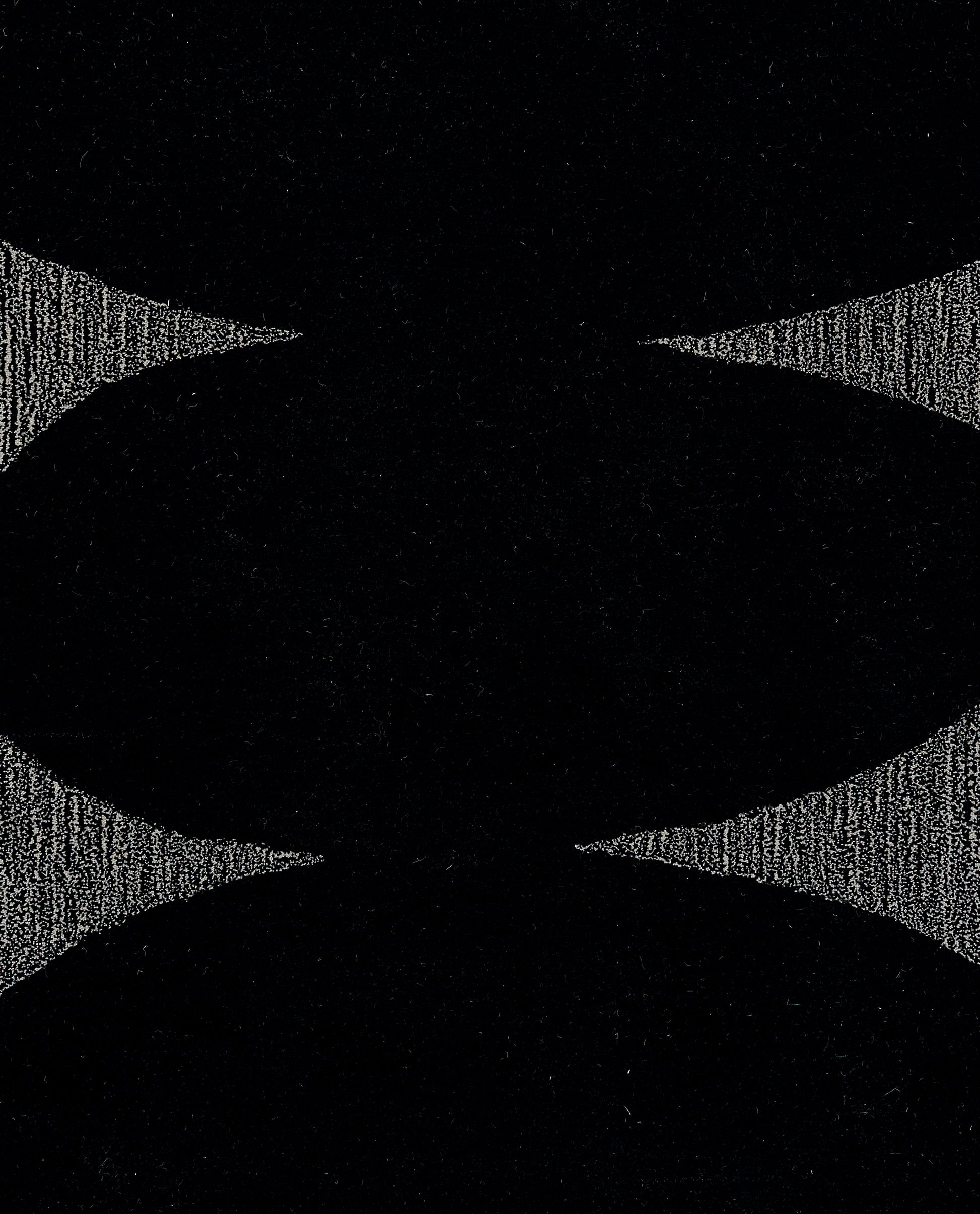 Black rug with curved silhouette and grey textured edges, bold abstract symmetrical design, 5' x 8'.