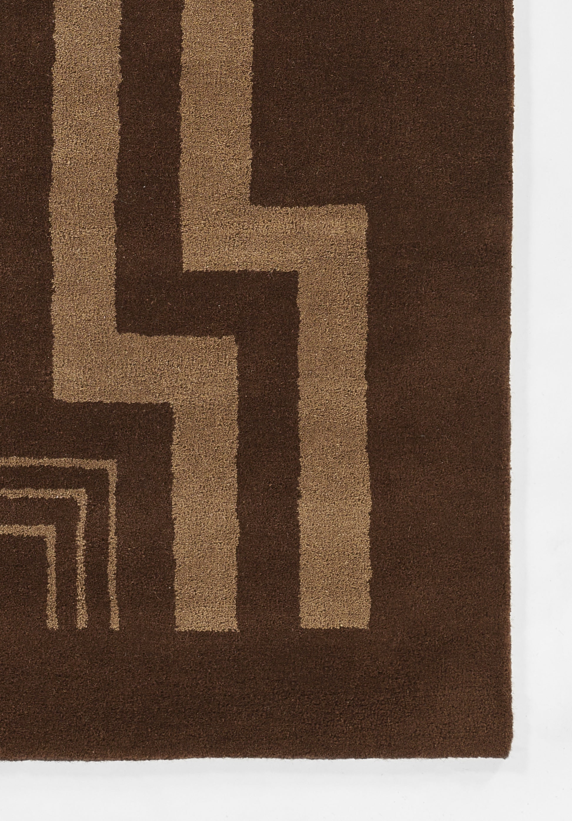 Brown rug with tan stepped geometric lines in a retro-modern plush-pile design.