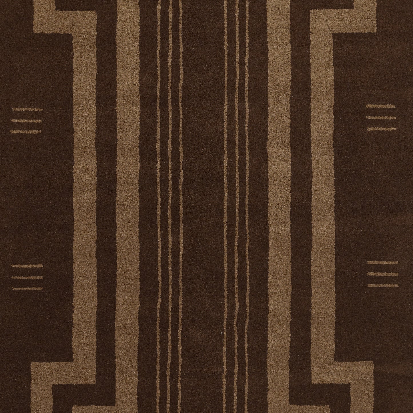 Brown geometric rug with tan linear tribal pattern and vertical stripe motifs.