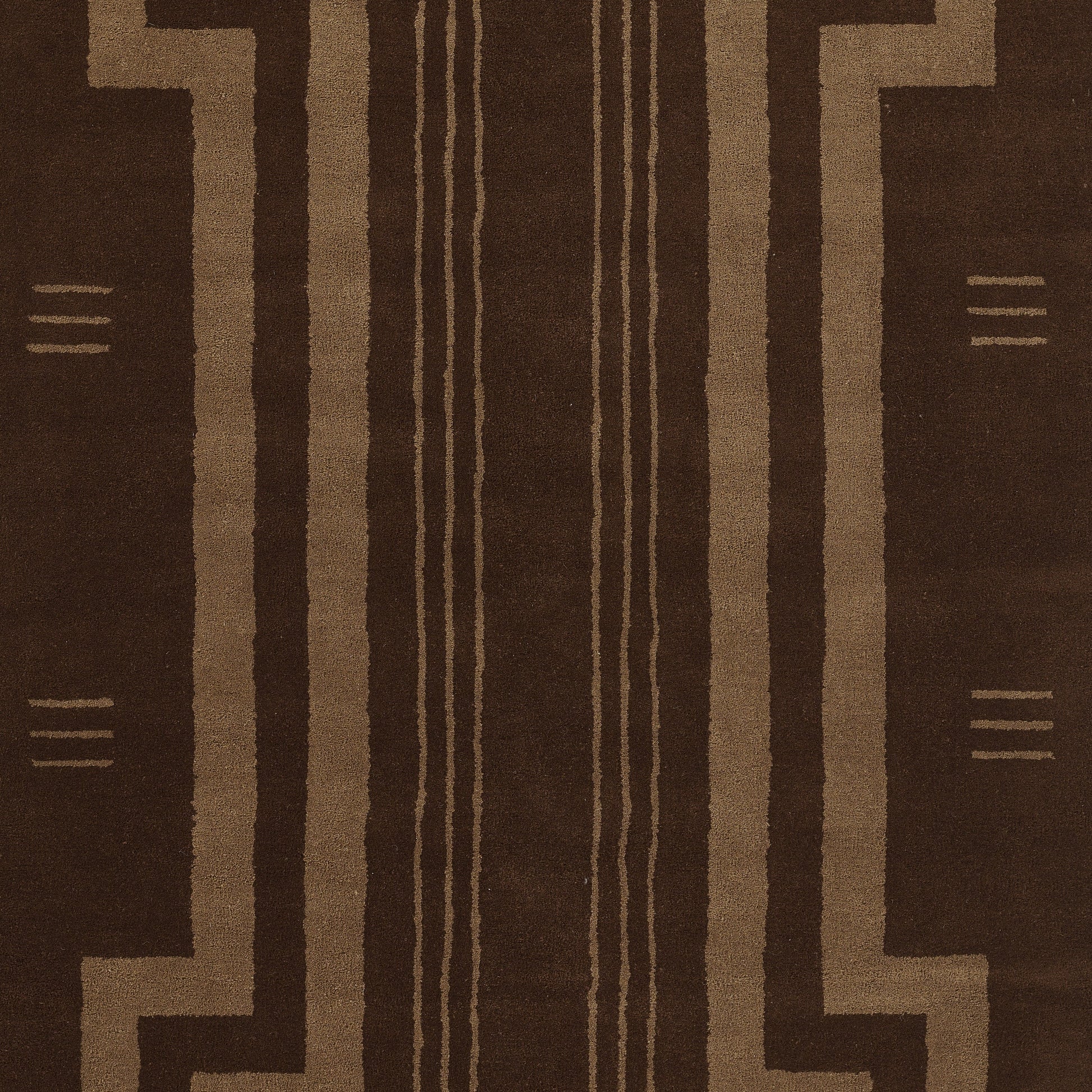 Brown geometric rug with tan linear tribal pattern and vertical stripe motifs.
