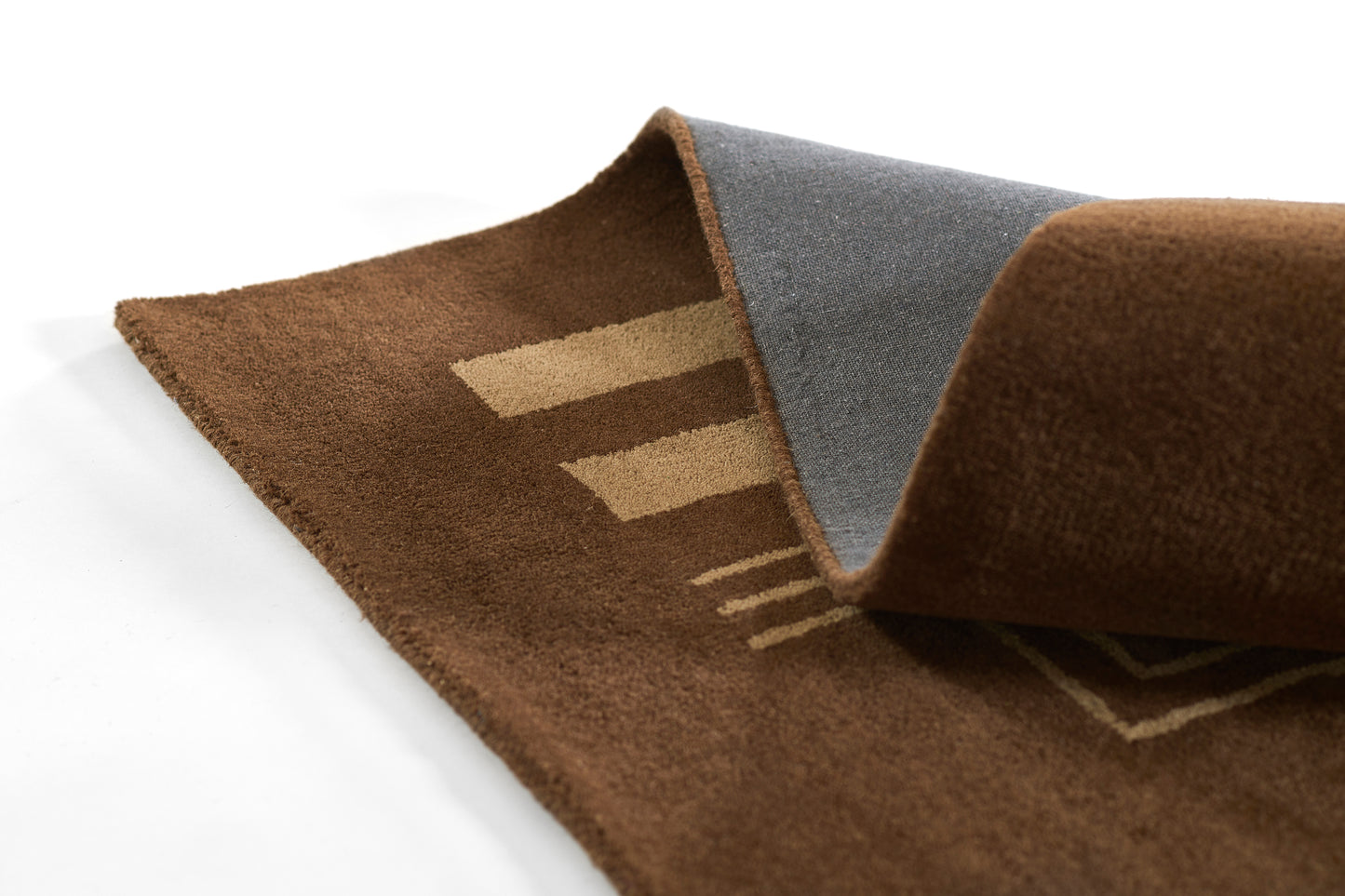 Brown plush rug with beige geometric stripes and a gray underside; soft, non-slip floor mat.