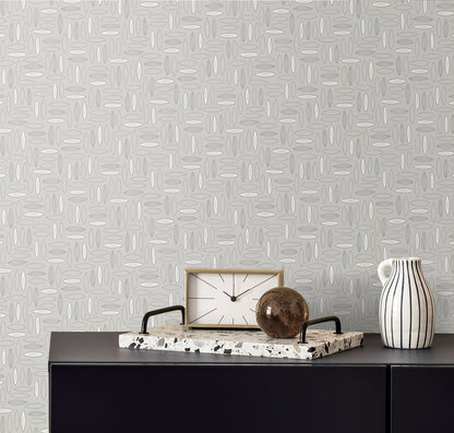 Grey patterned wallpaper, dark console with marble tray, wooden-framed clock, brown orb, and striped pitcher.