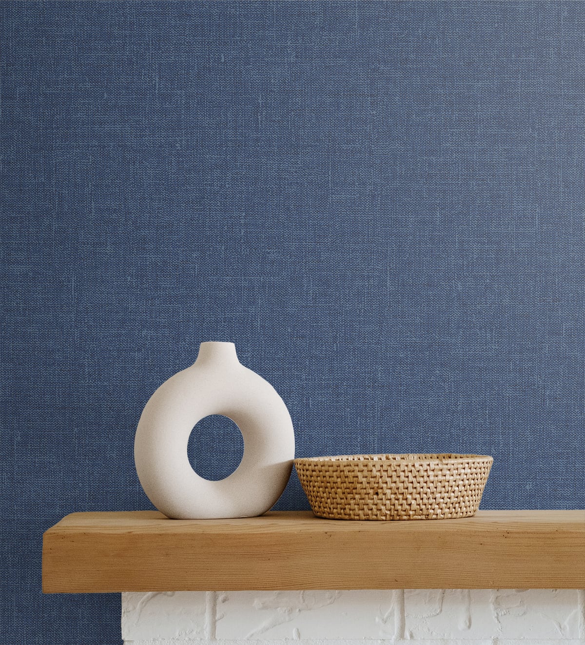 Soft blue matte linen fabric on a light wooden shelf.