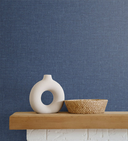 Soft blue matte linen fabric on a light wooden shelf.