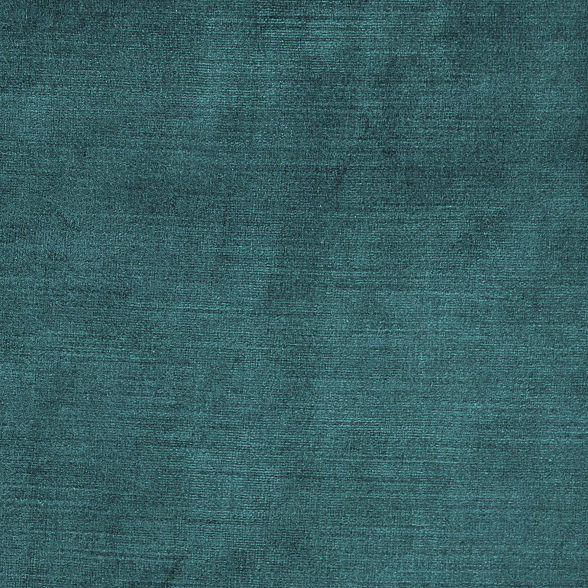 Teal textured fabric close-up with a velvet-like weave and subtle sheen.