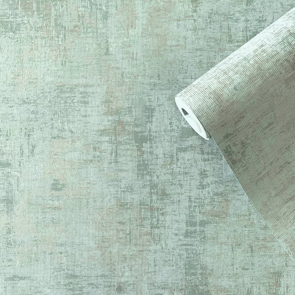 Mint green distressed textured wallpaper roll with curling top edge and subtle worn pattern.