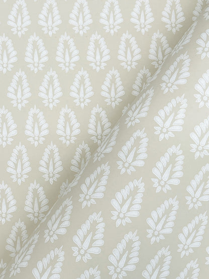 Beige wallpaper close-up showing a white leaf/feather repeating small-print pattern.