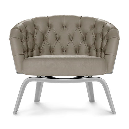 Gray solid fabric tufted barrel chair with button details and chrome curved legs for a modern lounge.