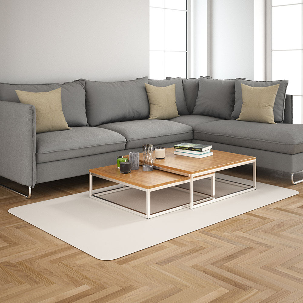 Vanilla solid fabric upholstery; lifestyle image of a grey sectional sofa with beige cushions and a two-tier wood-top coffee table on a white rug in a bright living room.