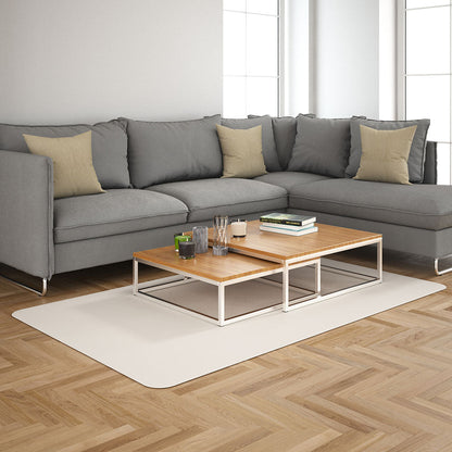 Vanilla solid fabric upholstery; lifestyle image of a grey sectional sofa with beige cushions and a two-tier wood-top coffee table on a white rug in a bright living room.