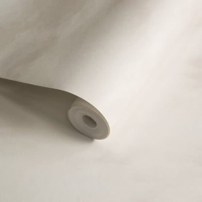 Beige wallpaper roll, partially unrolled, smooth matte vinyl with a cardboard core.