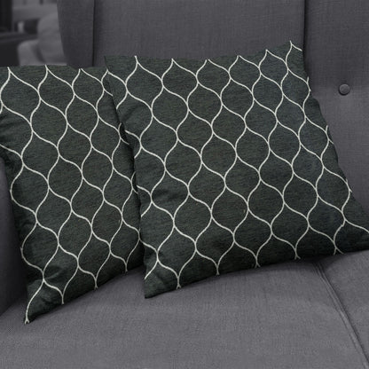 Two charcoal gray decorative pillows with a white geometric lattice pattern on a textured gray sofa, in Onyx Geometric fabric NJ25-3224.