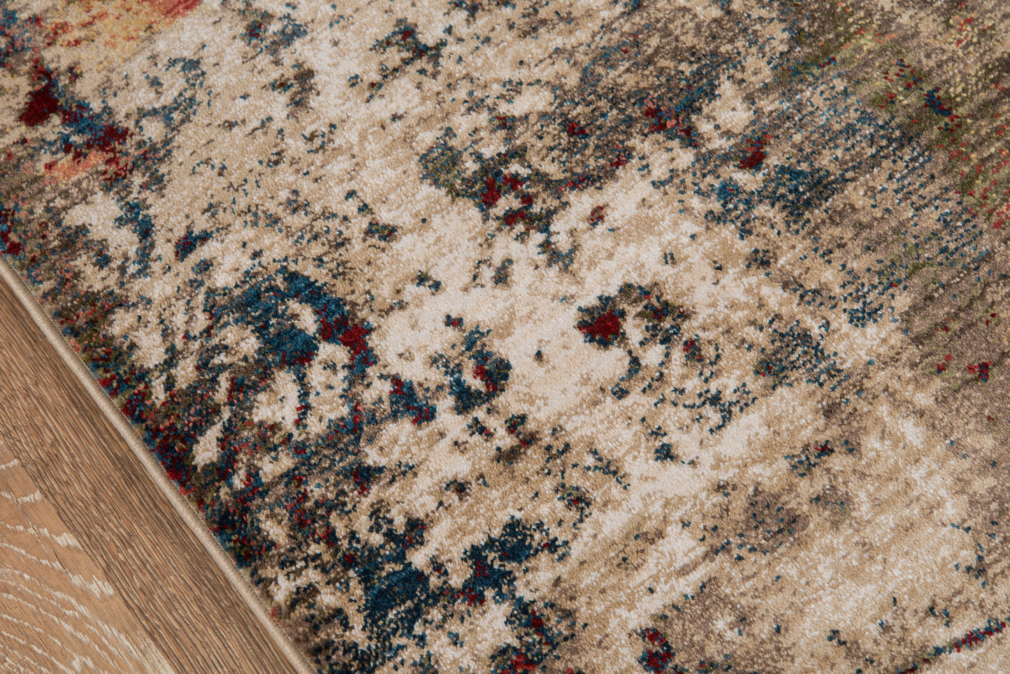 Beige distressed runner rug with blue, red and green accents on a wooden floor; vintage Persian-inspired pattern, 2'X8'.