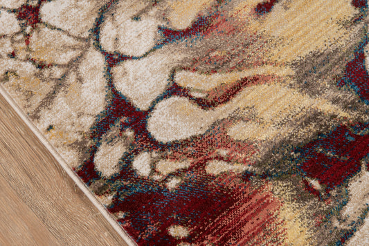 Rectangular abstract area rug with a beige base and red, blue, mustard accents on a wood floor.