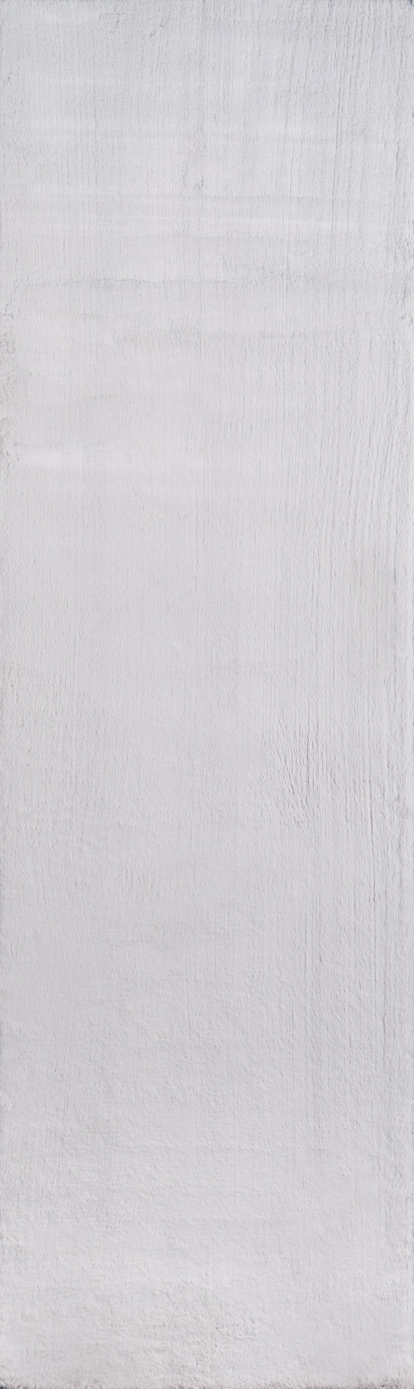 Light gray, textured painted wood surface with subtle grain and brush marks.