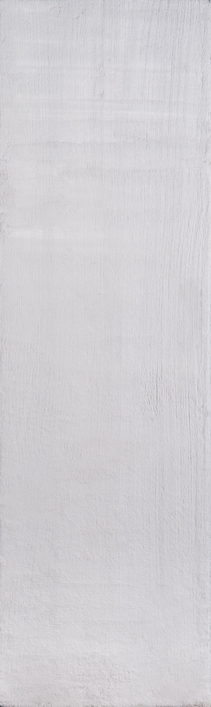 Light gray, textured painted wood surface with subtle grain and brush marks.