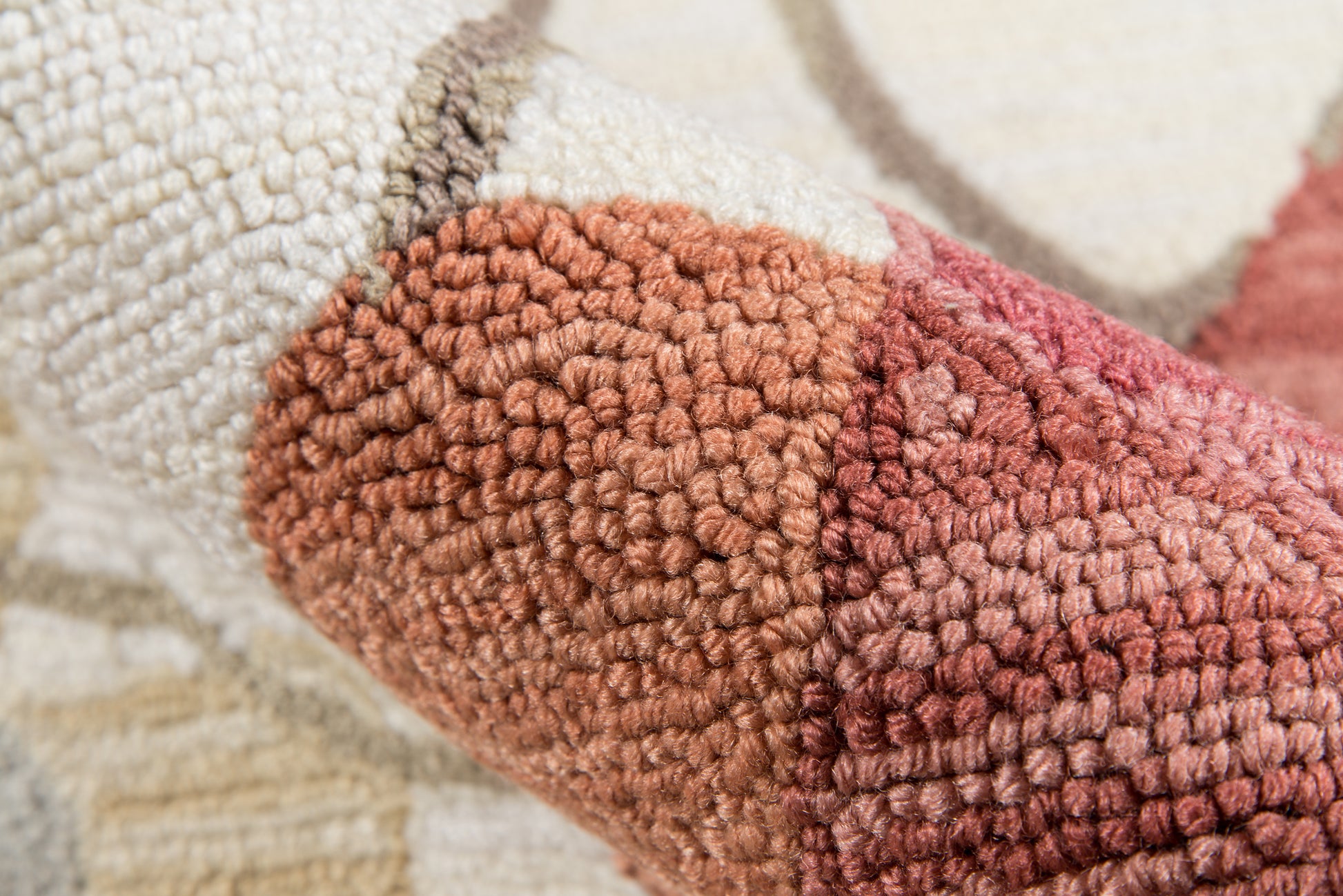 Close-up of a multi-color boucle rug with cream, beige, tan, rust and mauve hues; chunky loop pile, woven style.