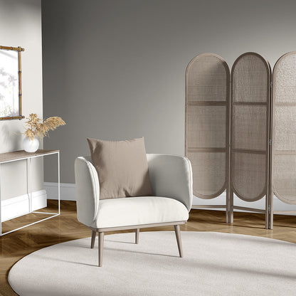Snow Chevron fabric in a neutral living room setting, shown on ivory upholstered armchair with beige cushion, light wood legs, round cream rug, and a wicker folding screen.