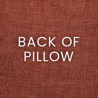 Close-up of sand terracotta woven pillow fabric with a coarse texture.