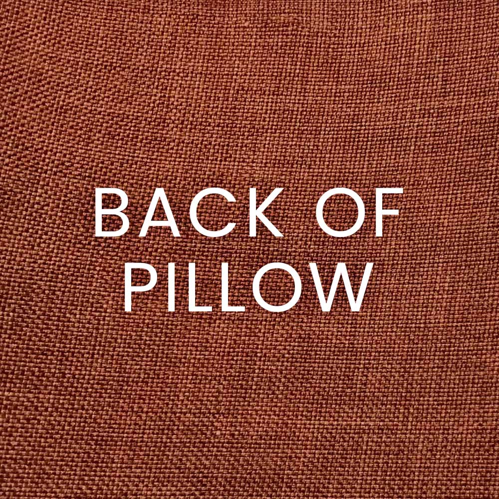 Back of pillow on sand-terracotta woven fabric with flame stripe pattern.