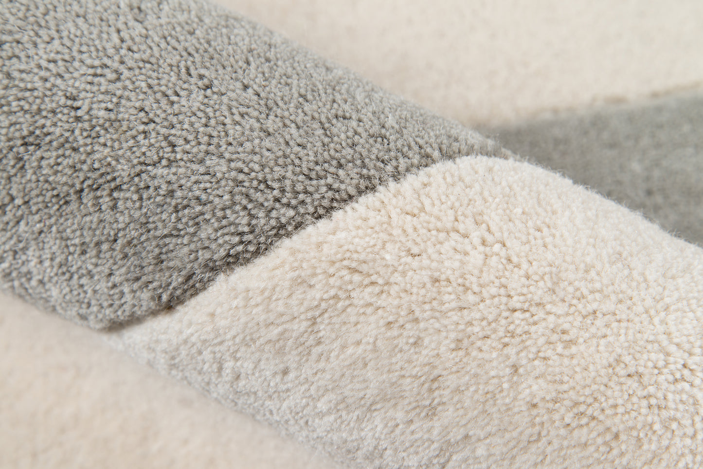 Close-up of plush two-tone sherpa pile in gray and beige on an 8' x 10' rug.