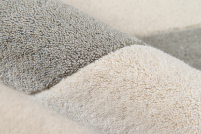 Close-up of plush two-tone sherpa pile in gray and beige on an 8' x 10' rug.