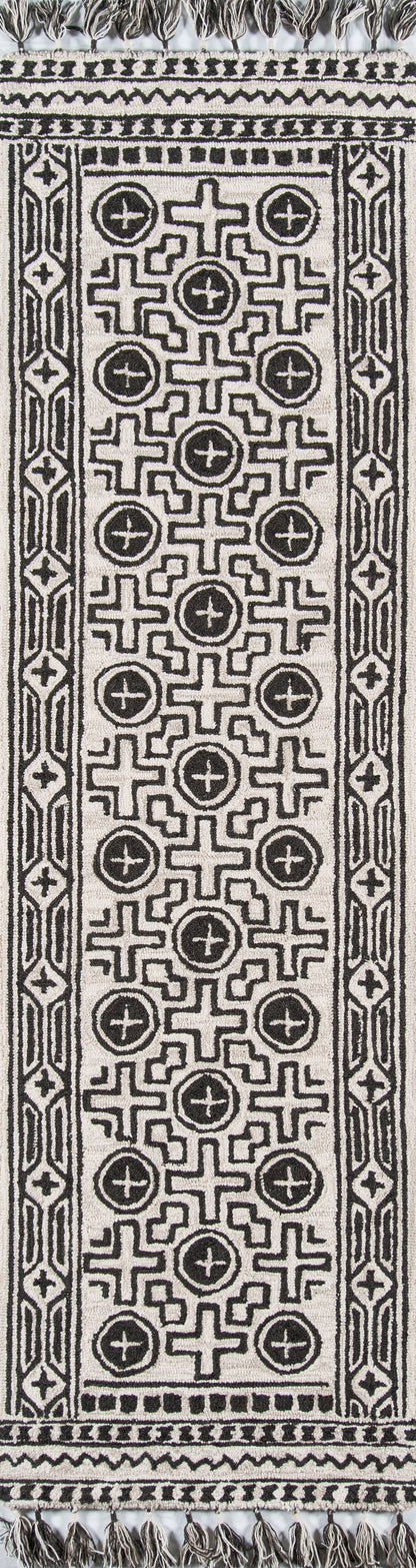 Black and ivory woven cotton runner rug with bold geometric cross and circular motifs, bordered by patterned trim and fringe.