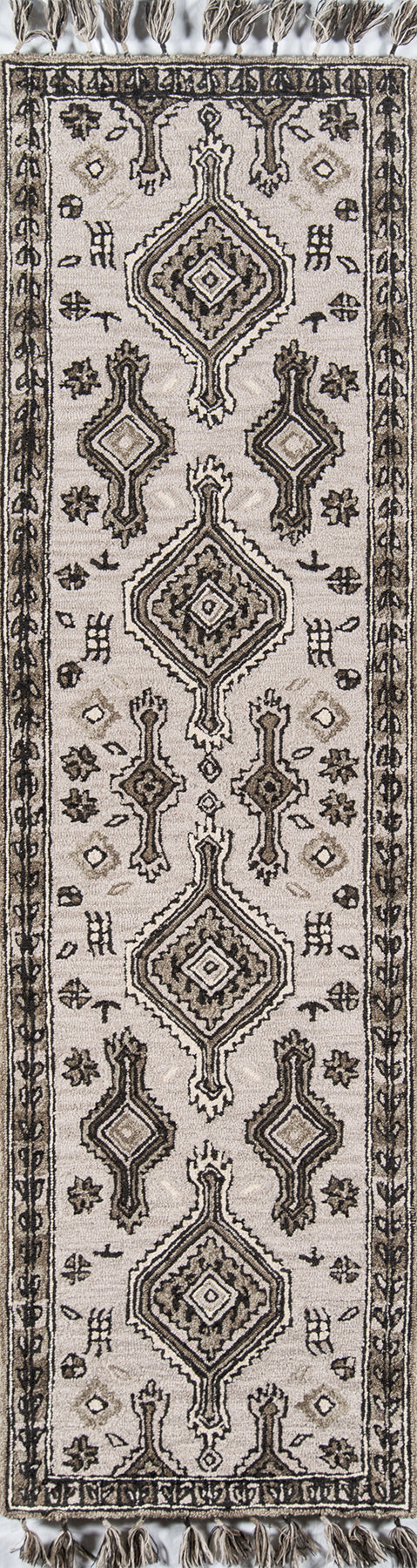 Grey-beige oriental rug with dark brown geometric medallions and fringe tassels.