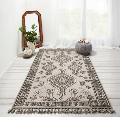 Beige rug with gray geometric medallions and fringed edges, boho style for living room decor.