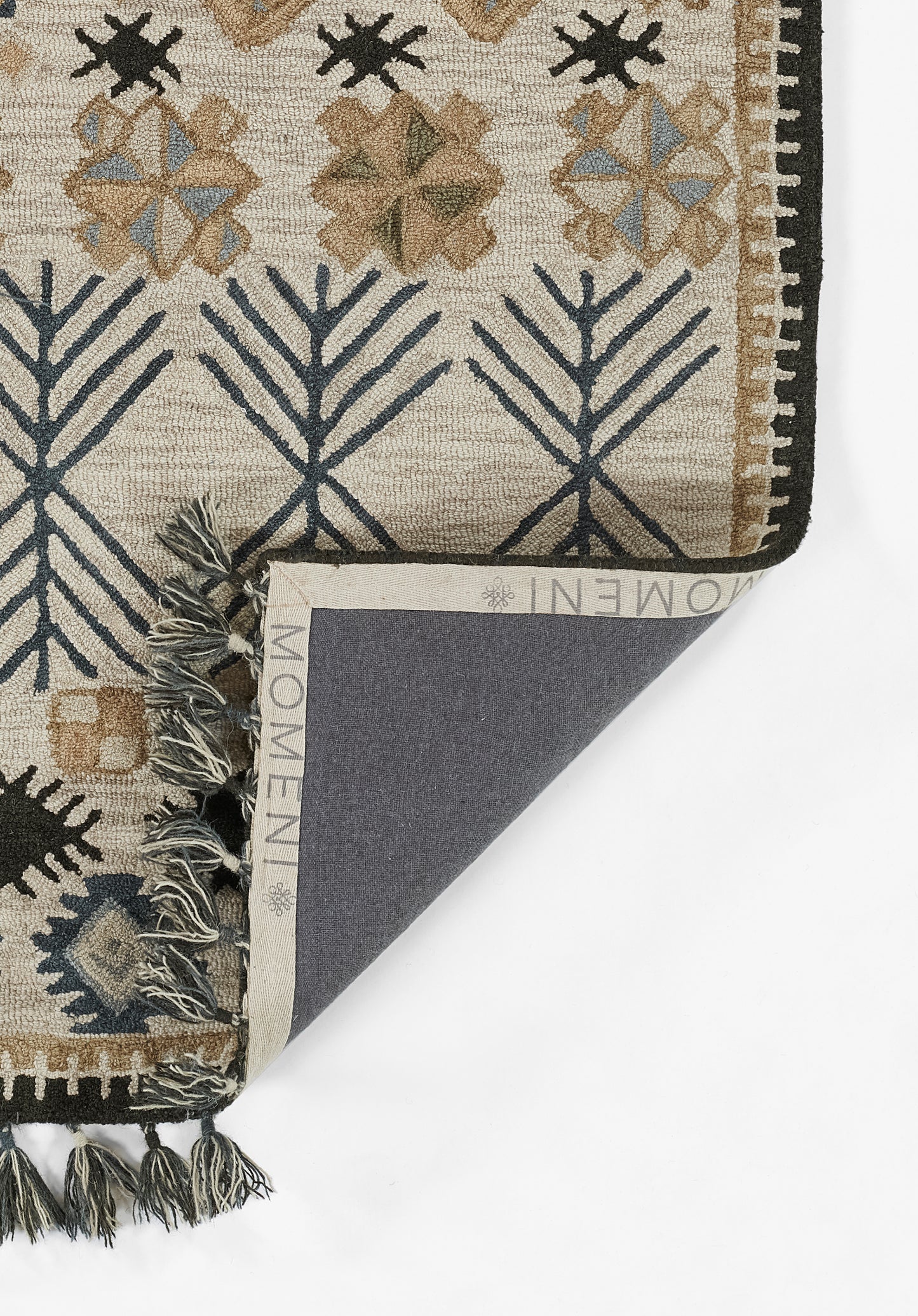 Beige flatweave wool rug with navy geometric tree motifs, tassels and dark border; shown folded to reveal back.
