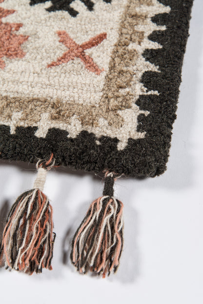 Woven rug with cream center, beige-brown border, black edge, orange X motif & multi-color tassel fringe, 7'6" x 9'6