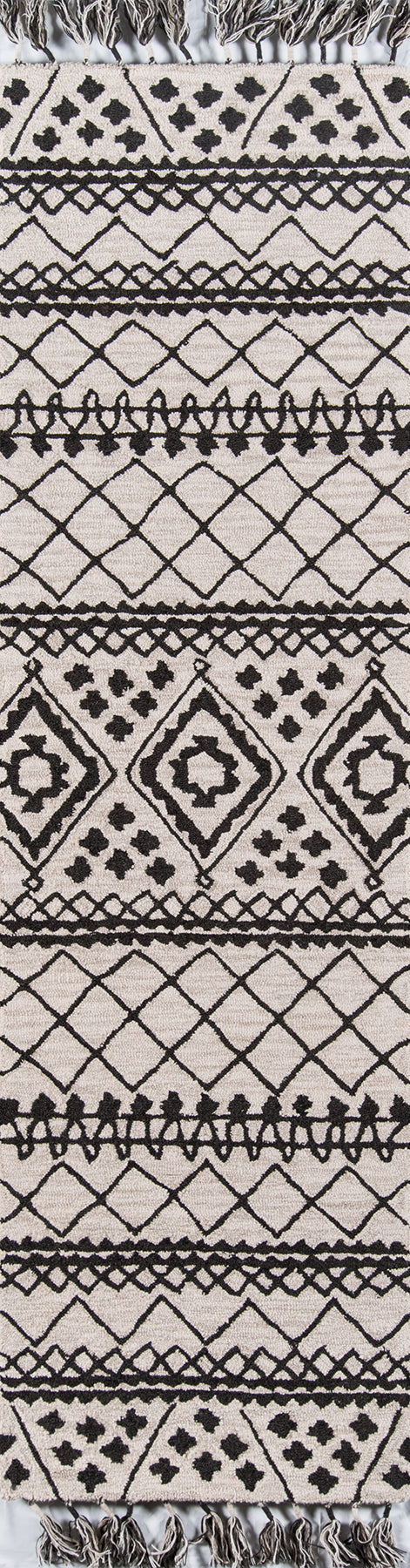 Gray woven rug with black geometric diamonds, lattices and triangles; fringed ends for decorative floor or wall hanging.
