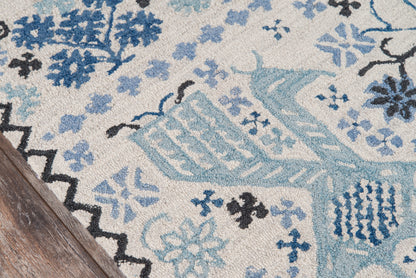 Rectangular beige rug with blue floral and geometric motifs; woven texture, aqua and navy accents, ideal for living room