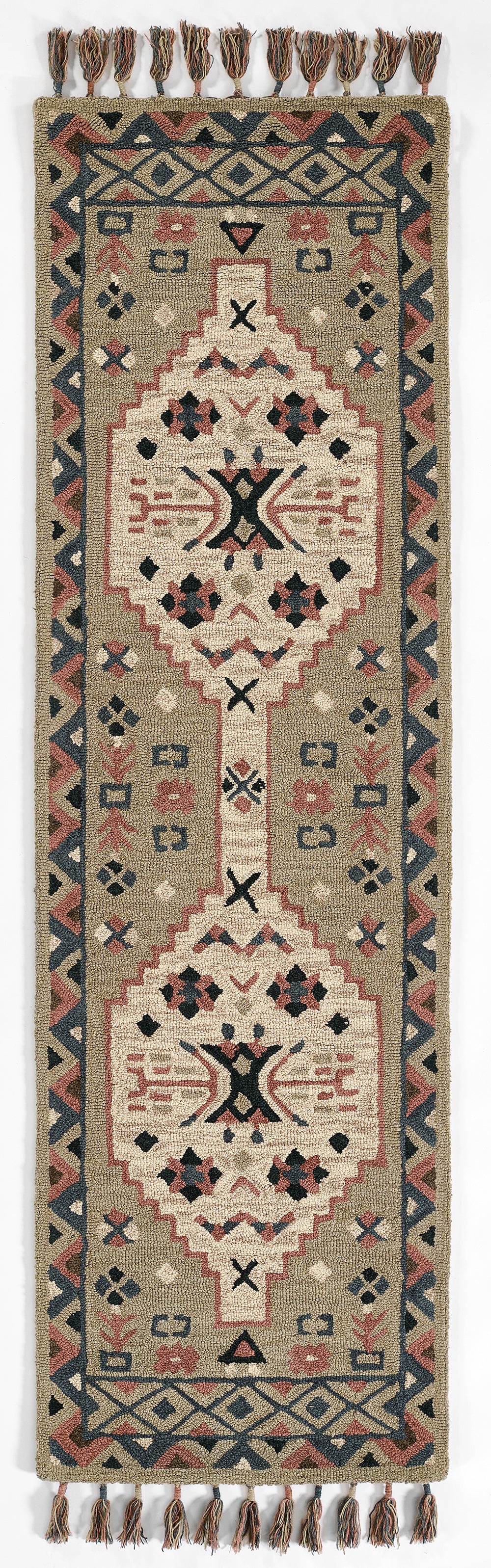 Kilim-style woven runner rug with geometric medallions and tassel fringe in beige, gray, navy, and dusty red.