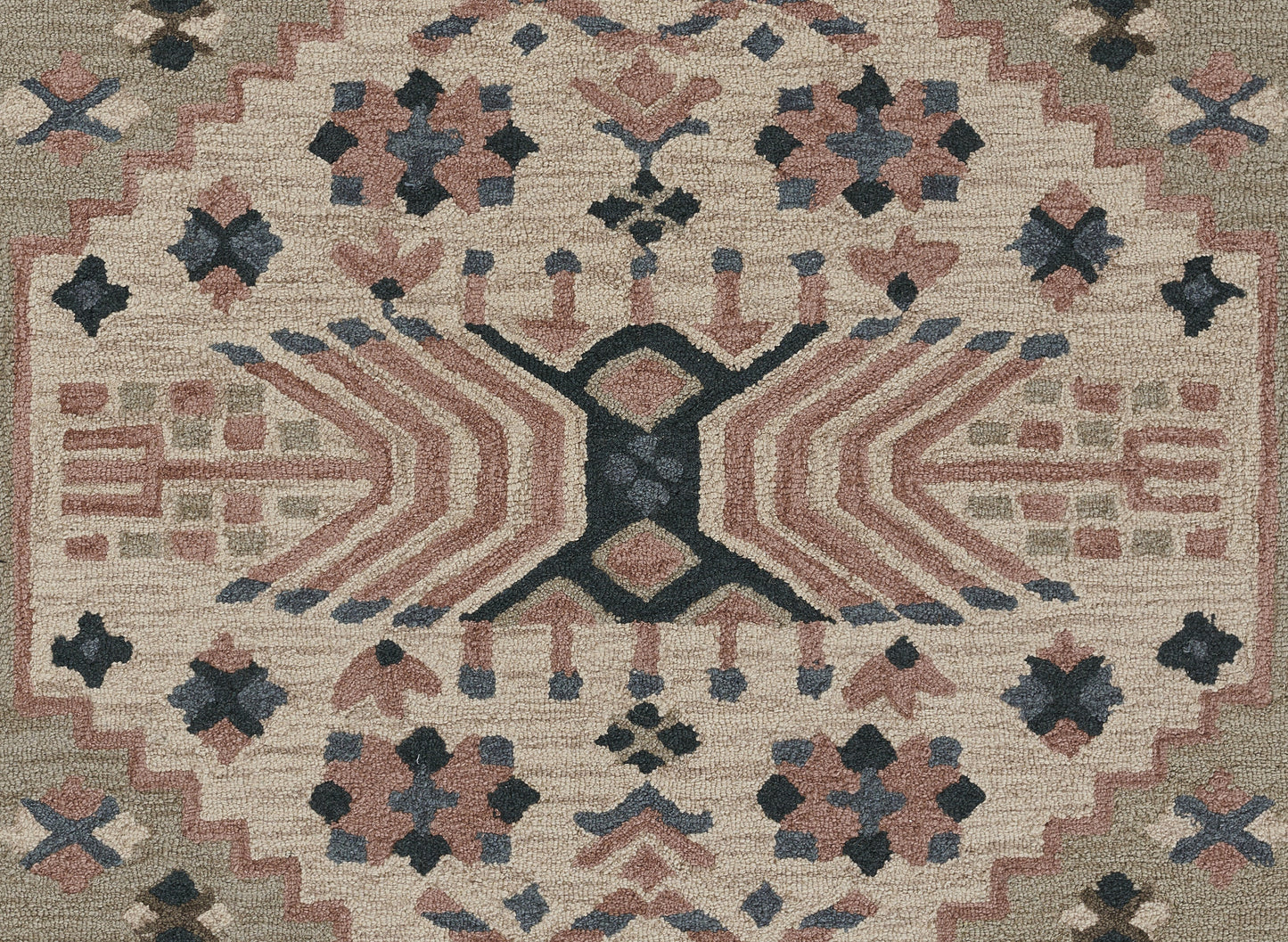 Tahoe-style beige geometric area rug with pink, navy and gray motifs, central X motif and zigzag border.