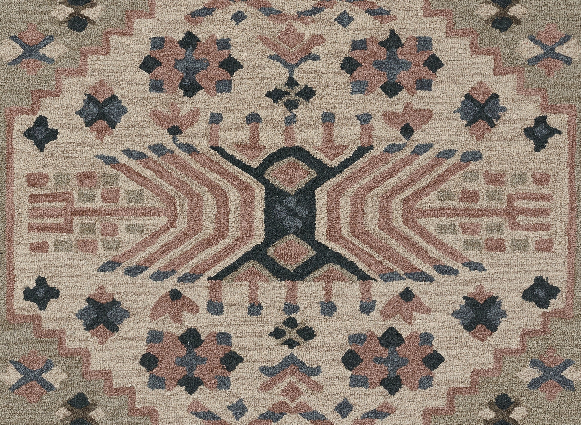 Tahoe-style beige geometric area rug with pink, navy and gray motifs, central X motif and zigzag border.