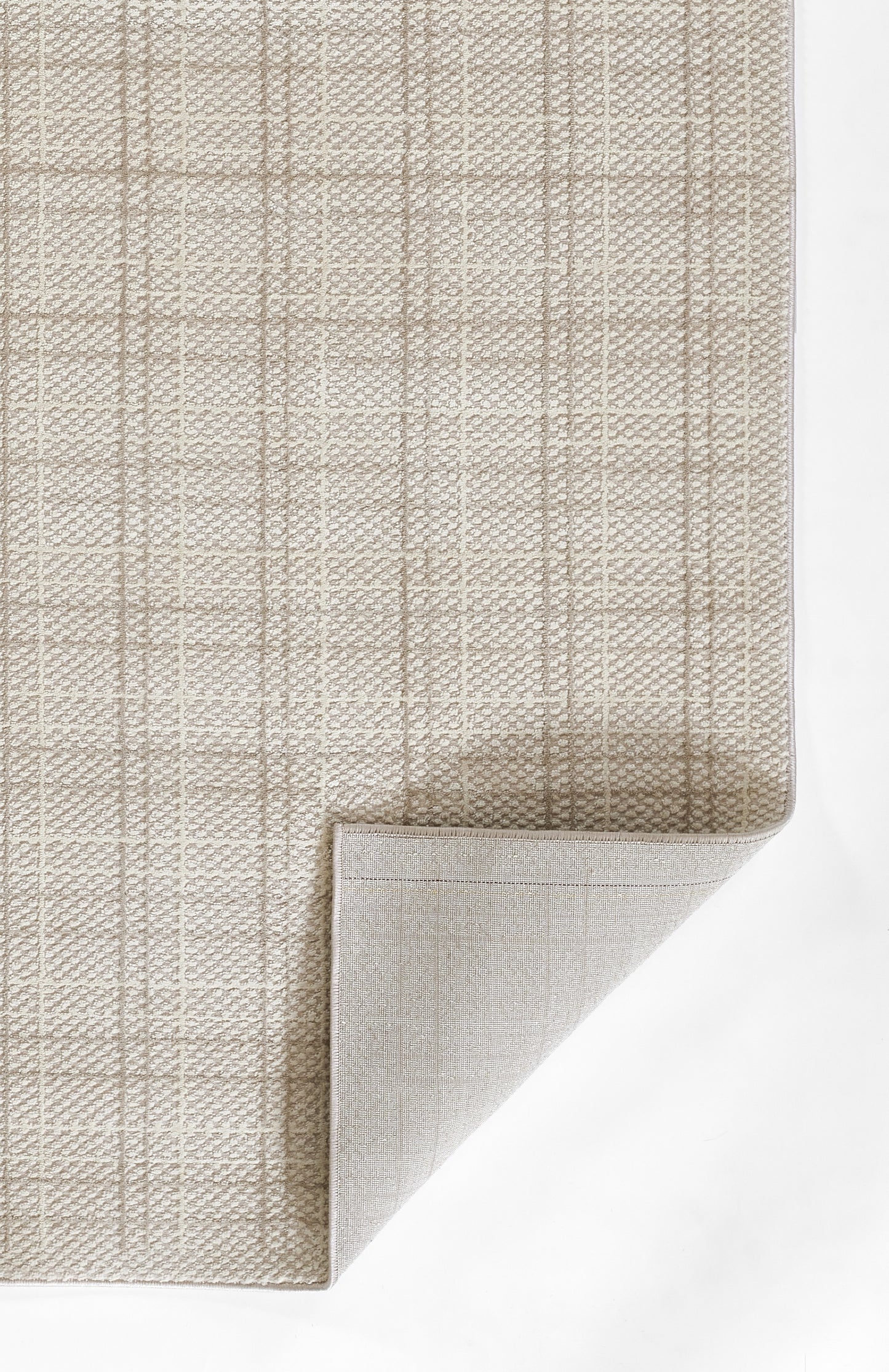 Beige TALIATLI rug with textured plaid grid, soft looped fibers; folded corner reveals lighter underside.