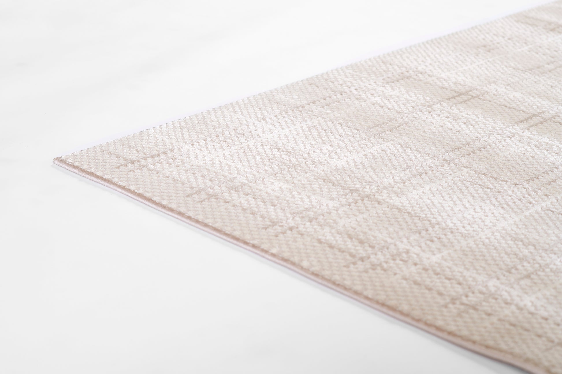 Beige flatwoven area rug with subtle geometric pattern; soft neutral tones, low-pile, rectangular.