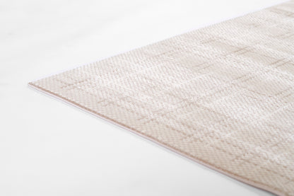 Beige textured area rug with subtle geometric pattern and pale pink edge; modern, versatile floor decor.