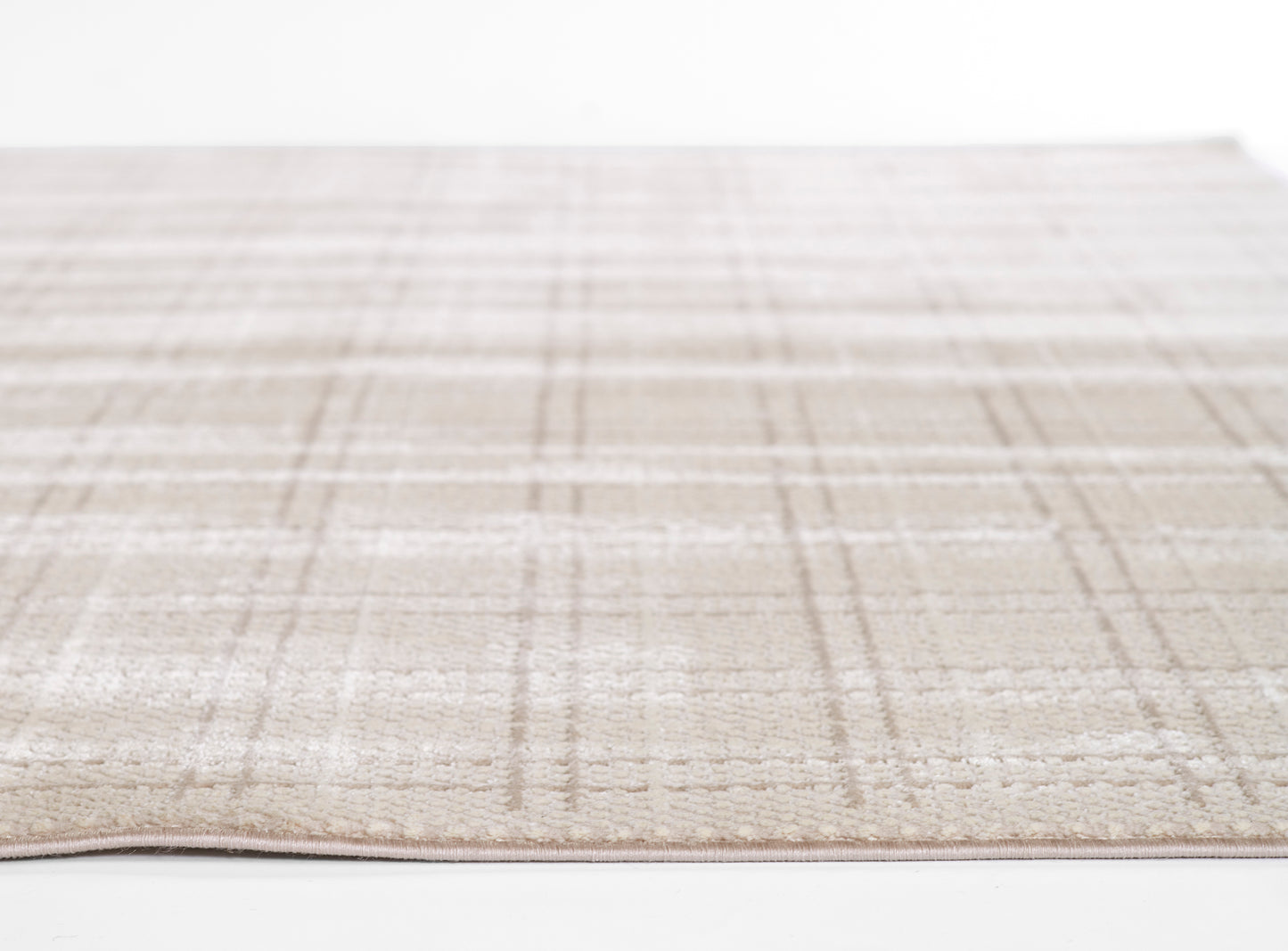 Beige plaid rug with soft, low-pile texture; cream base with taupe lines for a neutral living-room look.