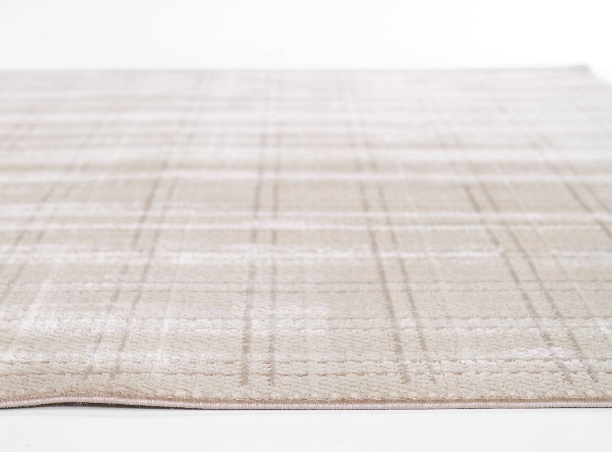 Beige plaid rug with soft, low-pile texture; cream base with taupe lines for a neutral living-room look.