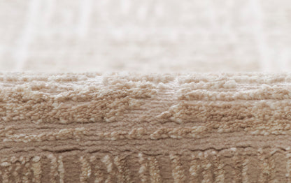 Beige shag rug close-up with thick plush pile in warm neutral tones.