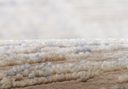 Cream beige shag rug with plush looped pile and subtle blue-gray flecks, soft textured decor.